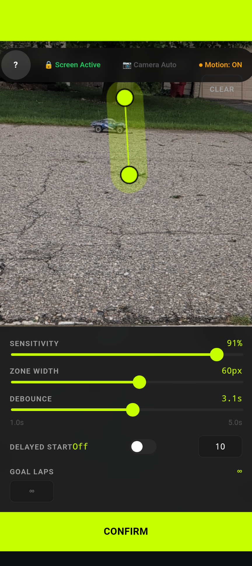 LapTrack viewfinder showing a live camera feed with an Electric Lime trigger zone line drawn across the finish line